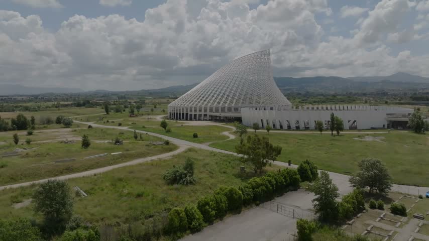 Aerial view of the Vela di Calatrava architectural structure surrounded by grassy fields and open landscape in Roma, Lazio, Italy.