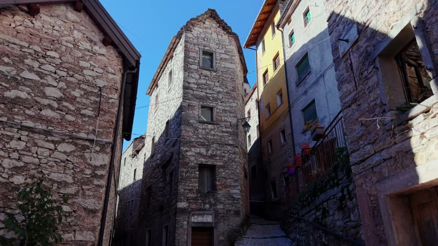 Aerial view of historic stone buildings lining a narrow street in the village of Pordenone, Friuli-Venezia Giulia, Italy.