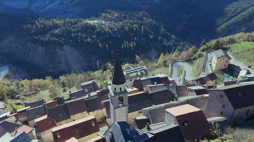 Aerial view of the historic village near Vajont Dam with stone houses and a church tower nestled in the mountains of Pordenone, Friuli-Venezia Giulia, Italy.