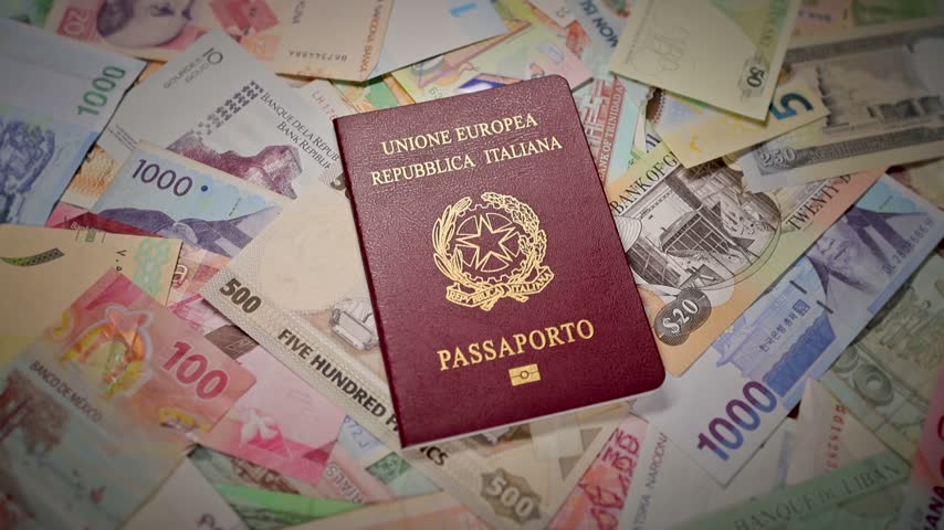 A Italian passport booklet labeled Unione Europea Repubblica Italiana Passaporto lying on assorted international banknotes