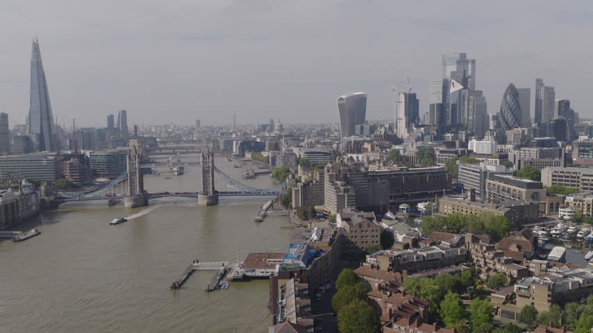 Establishing aerial view of London skyline featuring The Shard, Tower Bridge and the City of London. Iconic skyline of the capital of the United Kingdom