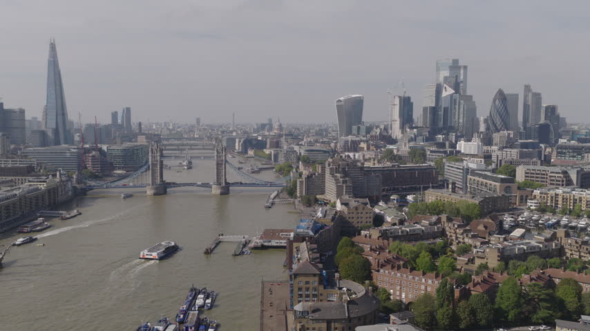 Establishing aerial view of London skyline featuring The Shard, Tower Bridge and the City of London. Iconic skyline of the capital of the United Kingdom