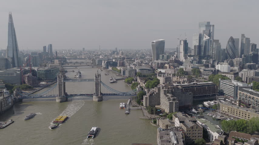 Establishing aerial view of London skyline featuring The Shard, Tower Bridge and the City of London. Iconic skyline of the capital of the United Kingdom