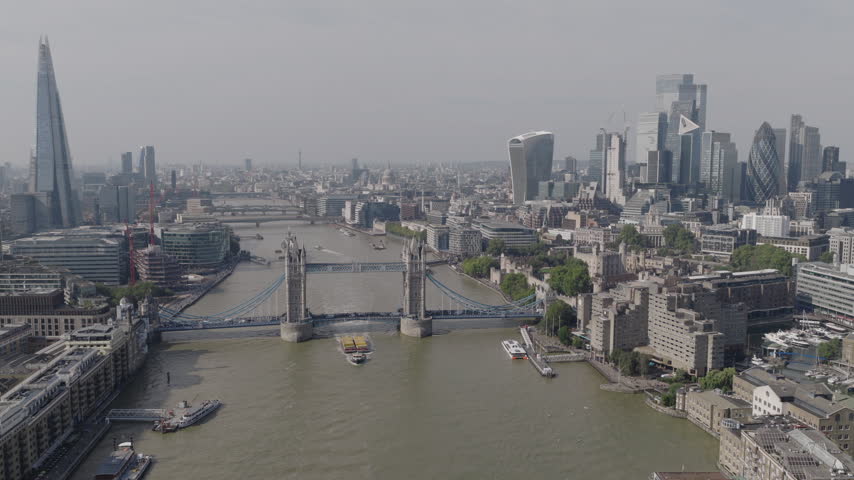 Establishing aerial view of London skyline featuring The Shard, Tower Bridge and the City of London. Iconic skyline of the capital of the United Kingdom