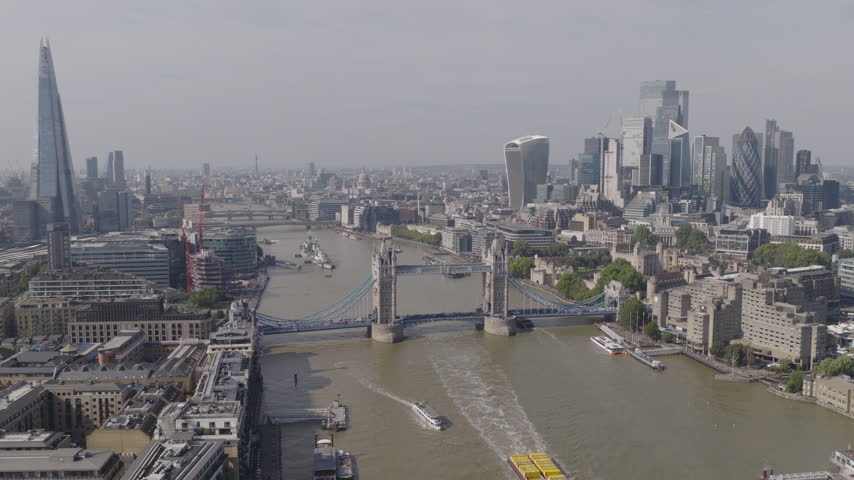 Establishing aerial view of London skyline featuring The Shard, Tower Bridge and the City of London. Iconic skyline of the capital of the United Kingdom