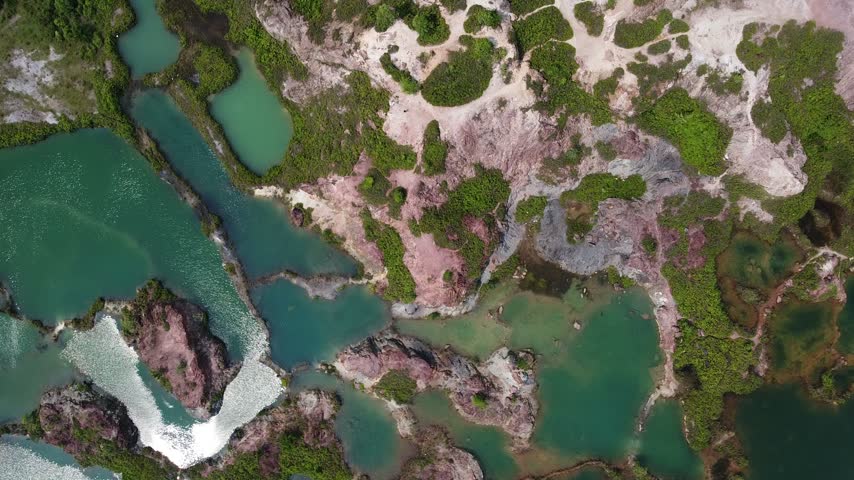Aerial landscape showing a series of peaceful lakes surrounded by exposed rock and vegetation.