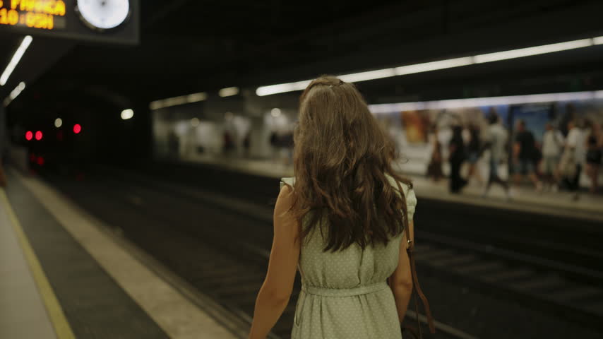 Female Tourist Waiting for Metro Train at Barcelona Underground Station Spain