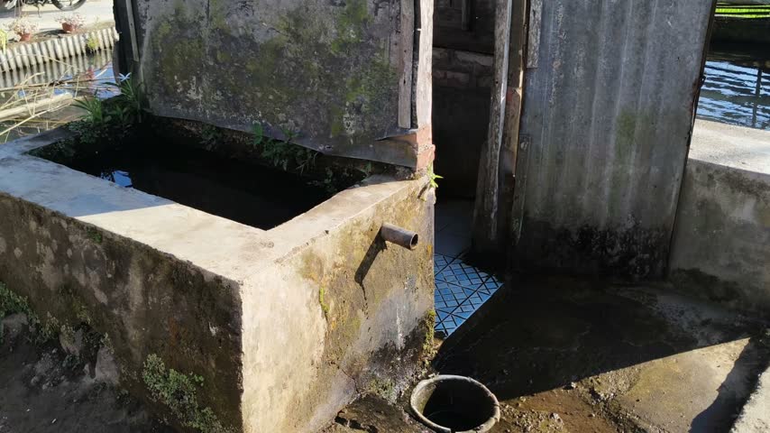 Traditional rural outdoor bathroom and washing area with water pool and tiled floor