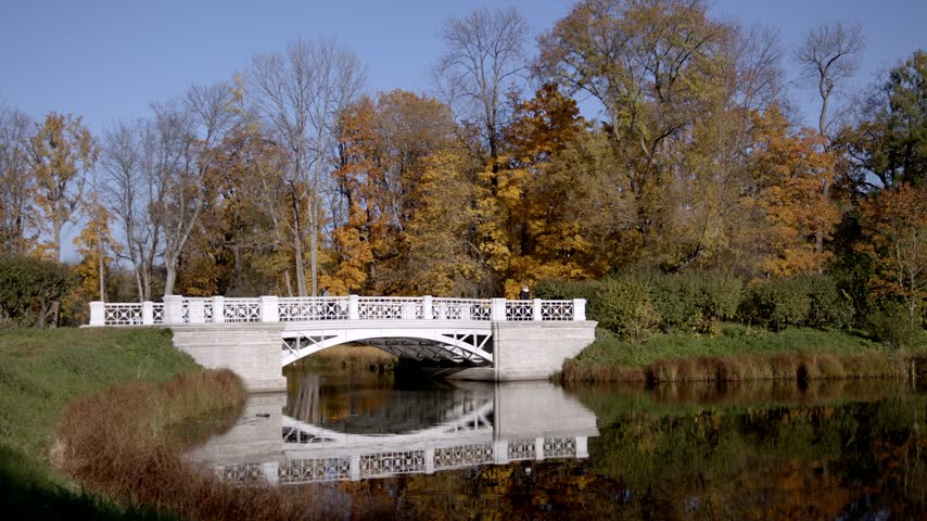 White Bridge Over Pond in Autumn Park