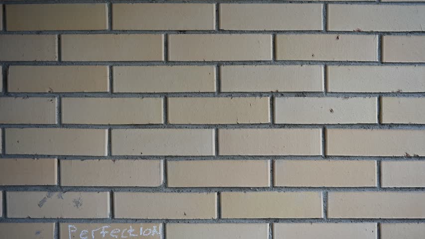 Overview of a brick wall with graffiti