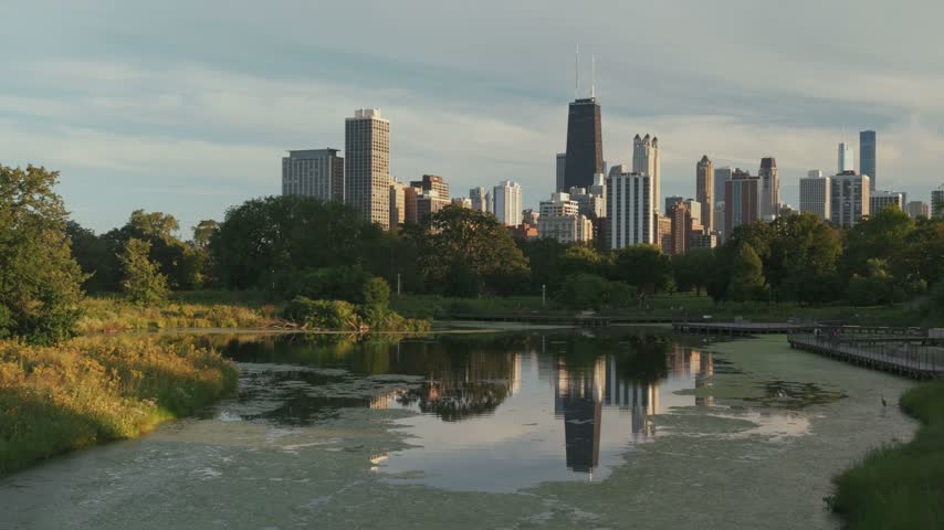 Chicago skyline sunset view from lincoln park nature preserve with pond reflection cityscape illinois