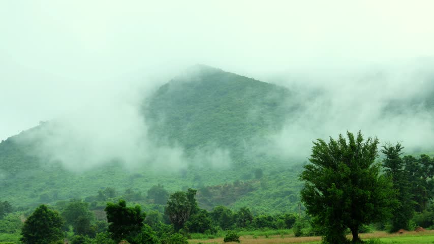 Moving Clouds Over Misty Green Mountains and Countryside