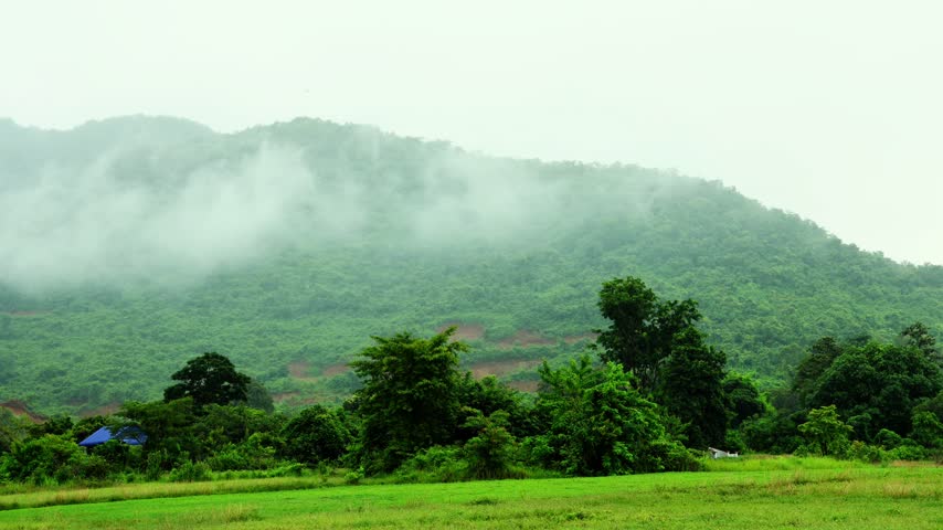Moving Clouds Over Misty Green Mountains and Lush Countryside