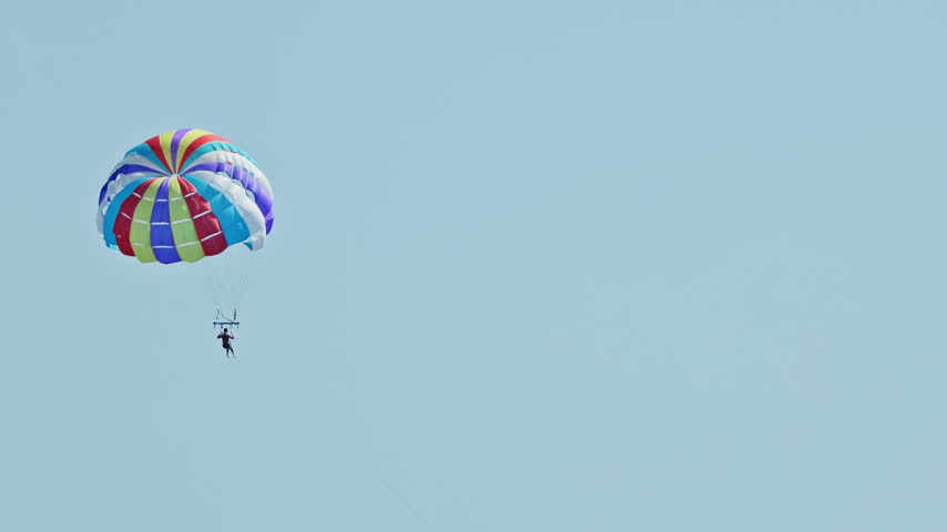 a man parasailing over the sea in barcelona