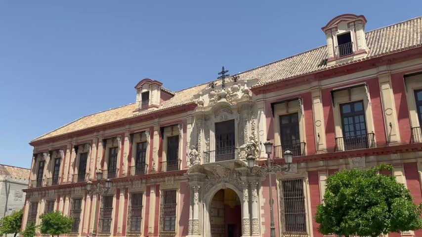 Historic palace exterior in Seville, Spain, featuring ornate architecture, decorative details and distinctive Spanish design