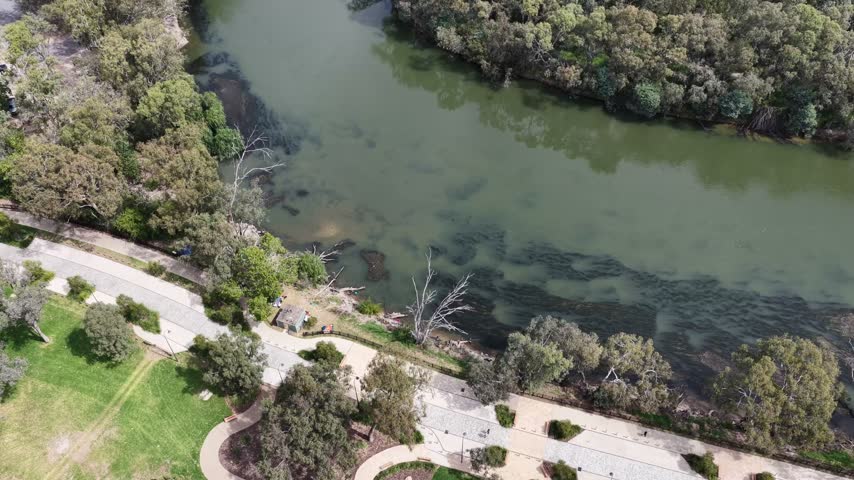 Murray river waters at Albury city parks in hilly area of rural regional Australia – aerial.