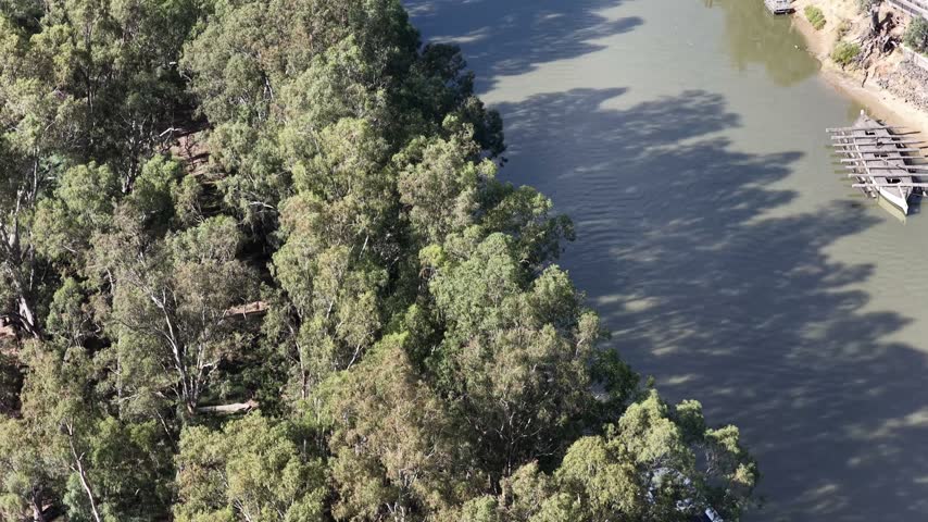 Banks of Murray river with paddle steamer boats at jetty Port of Echuca in Victoria, Australia.