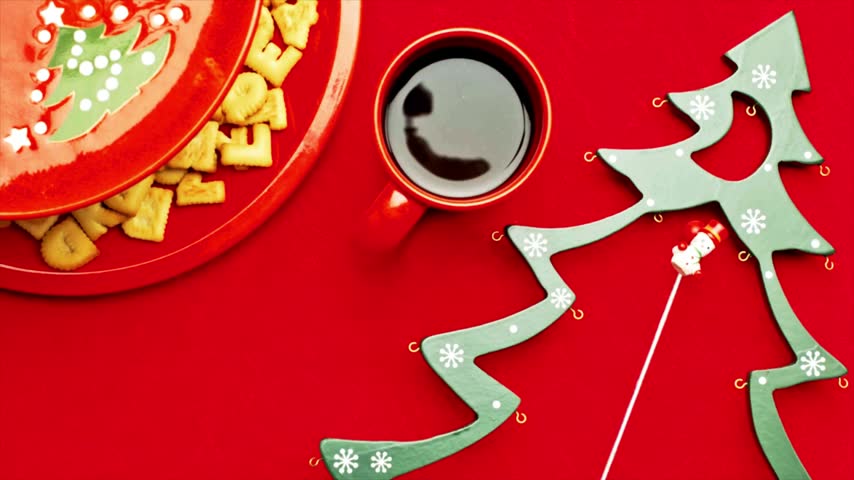 Christmas message spelled out using alphabet cookies on a vibrant red table during winter holidays video clip