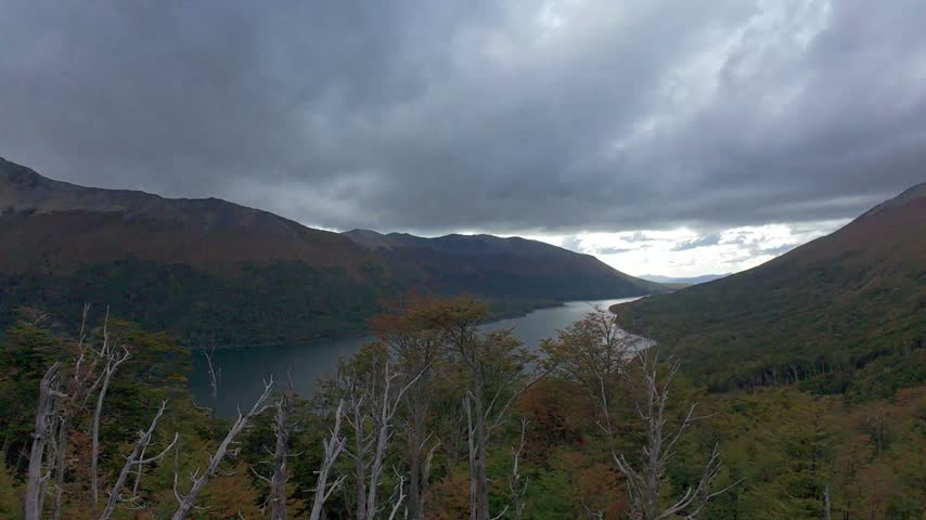 Slow Camera Zoom Toward A Mountain Lake Surrounded By Forested Mountains In Tierra Del Fuego Argentina