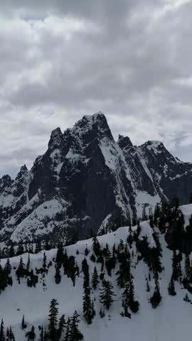 Majestic Snow-Capped Mountain Peak and Evergreen Forest in British Columbia, Canada