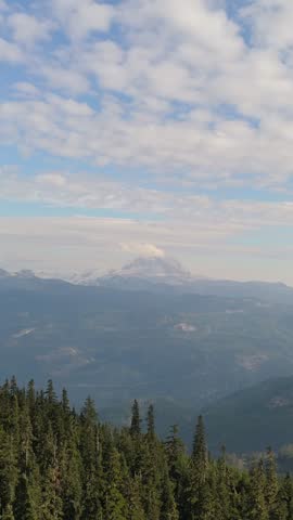 Majestic Mountain Landscape with Lush Forests Under a Blue Sky in British Columbia, Canada
