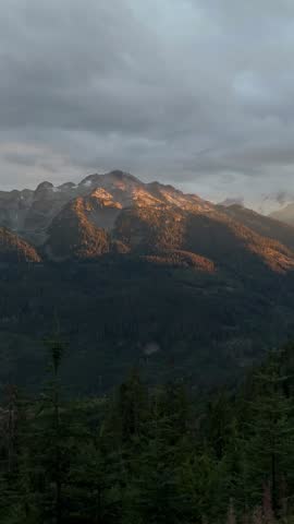 Golden Hour Sunlight Bathes Majestic Mountains and Lush Forests in British Columbia, Canada