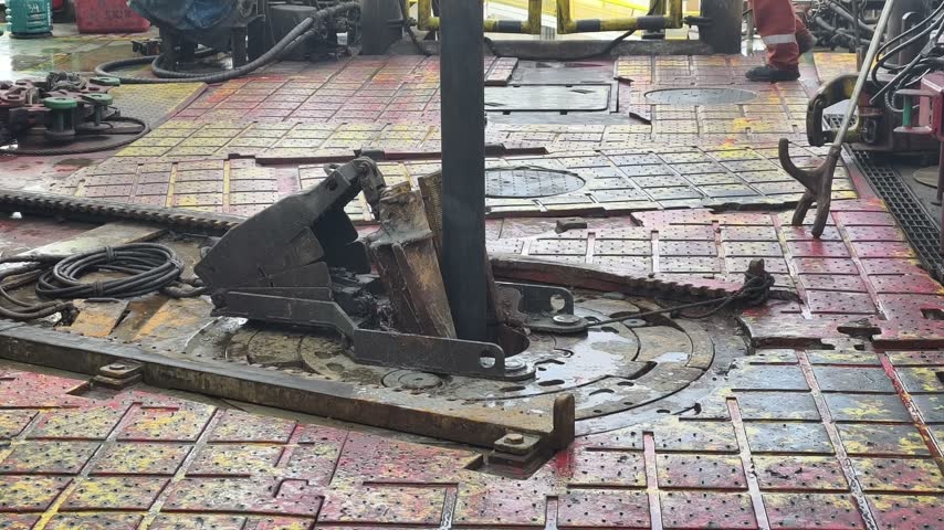 Drilling rig activity - Pull of of hole drill string with oil based mud on the rig floor. Trip out of hole.

