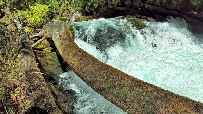 A high angle view of a powerful stream flowing over rocks in nature.