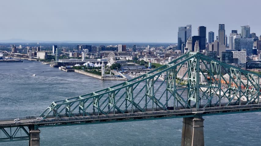 Aerial view of Montreal city skyline and the Jacques Cartier Bridge over the St. Lawrence with downtown in the background. g.