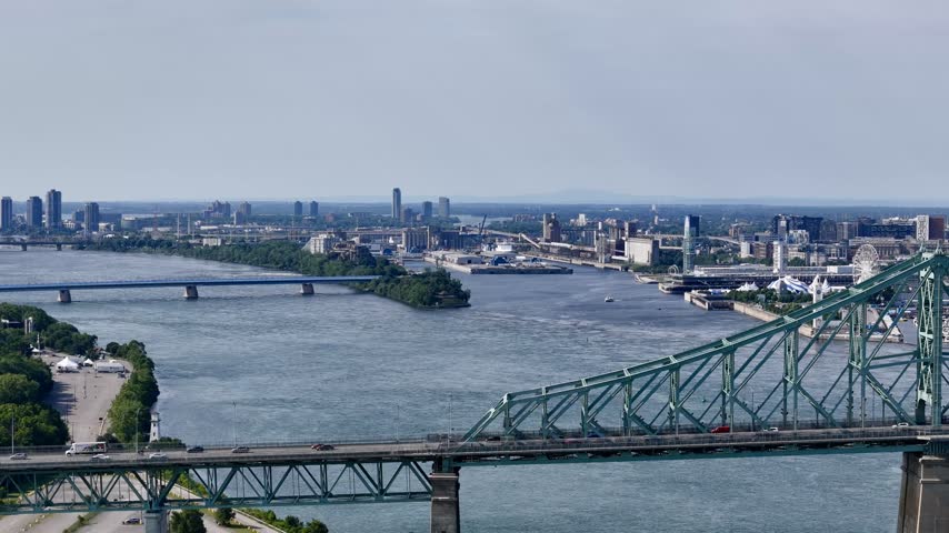Aerial view of Montreal city skyline and the Jacques Cartier Bridge over the St. Lawrence with downtown in the background. g.