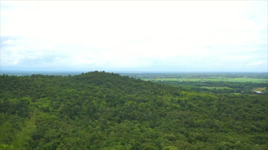 Aerial view of mountains beneath a bright morning sky, creating a peaceful and scenic natural landscape.