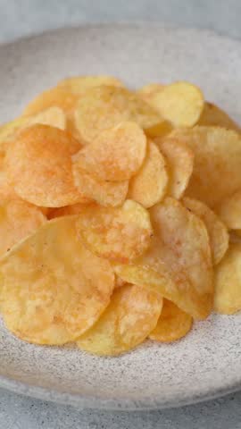 Crispy potato chips, golden slices seasoned with salt and spices. Potato chips