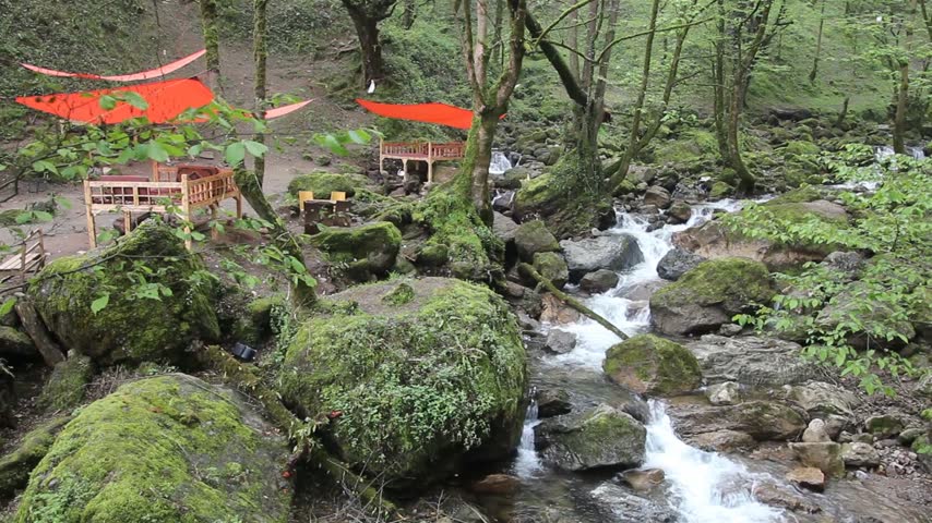 Small stream and an open air restaurant near Rudkhan castle in Iran