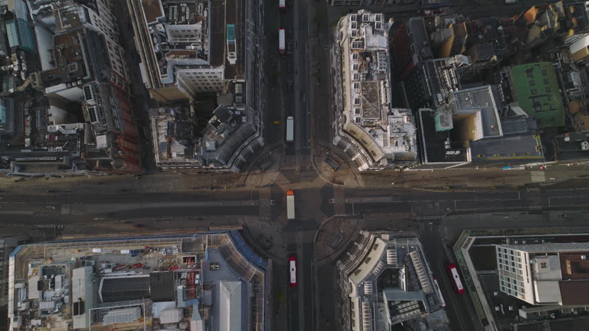 Bright daylight across Oxford Circus, Superb Quality, aerial view shot of Central London, England, United Kingdom showing the famous junction of Oxford Street and Regent Street with surrounding West End buildings and busy city streets, crystal clear crisp image