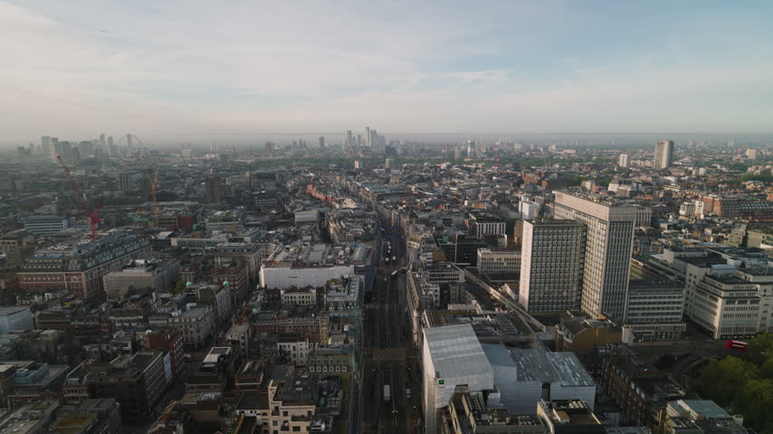 Bright daylight across Oxford Circus, Superb Quality, aerial view shot of Central London, England, United Kingdom showing the famous junction of Oxford Street and Regent Street with surrounding West End buildings and busy city streets, crystal clear crisp image