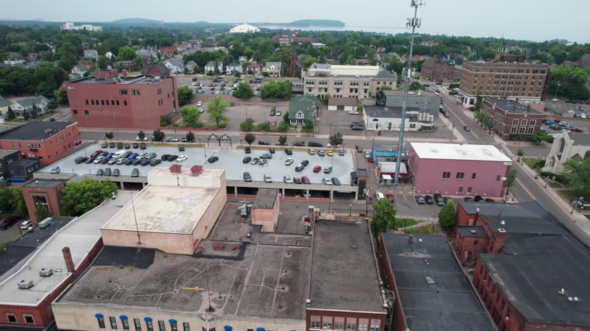 Fast orbital Aerial of Marquette Michigan on an overcast summer day in the Upper Peninsula.