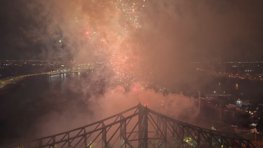 Holiday fireworks above water with reflection on the black sky background.