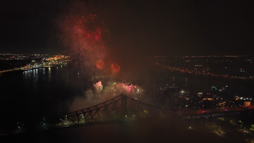 Holiday fireworks above water with reflection on the black sky background.