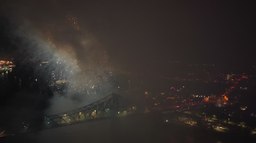 Holiday fireworks above water with reflection on the black sky background.