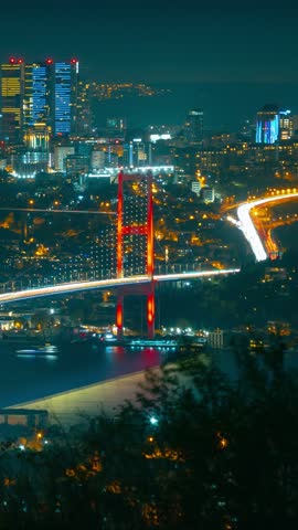 Bosphorus Bridge at night. A view of Istanbul city from Camlica Hill. Istanbul timelapse vertical video.
