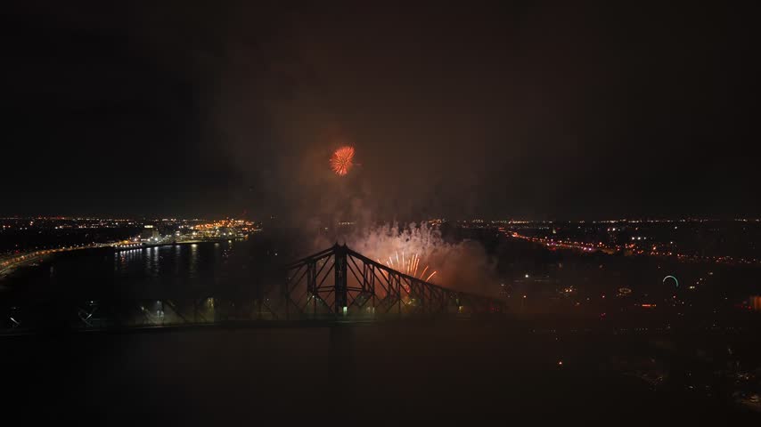 Holiday fireworks above water with reflection on the black sky background.