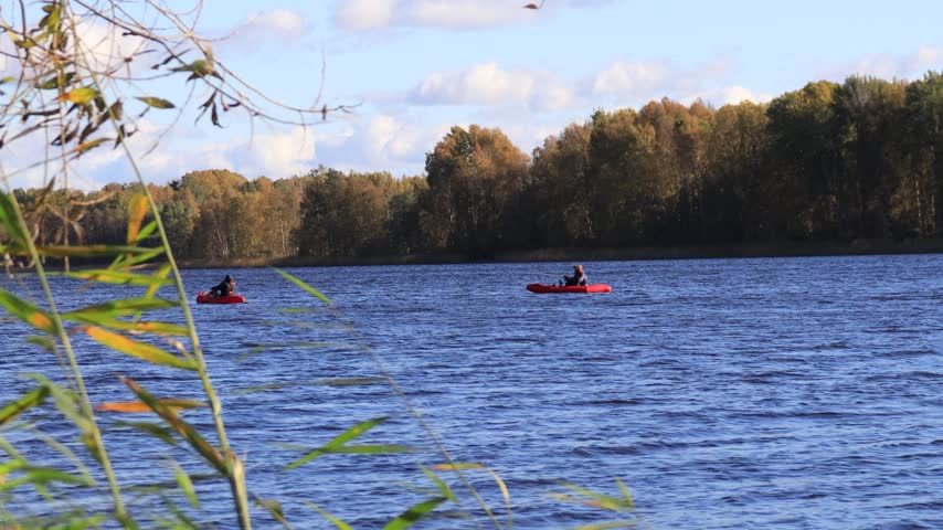 Two boats on the river on a sunny autumn day.