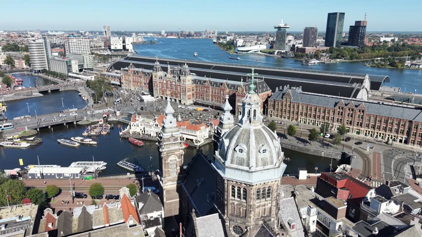 Central Train Station In Amsterdam In North Holland Netherlands. Downtown District. Train Station. Medieval Church. Central Train Station In Amsterdam. Amstel Riverfront. Beautiful Skyline.