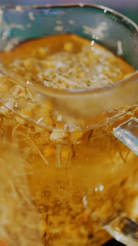 Herbal tea in a teapot. tea drink. close-up. three glass teapots with different herbal, colorful tea. leafy floral, crushed mint, lime, linden and chamomile tea.
