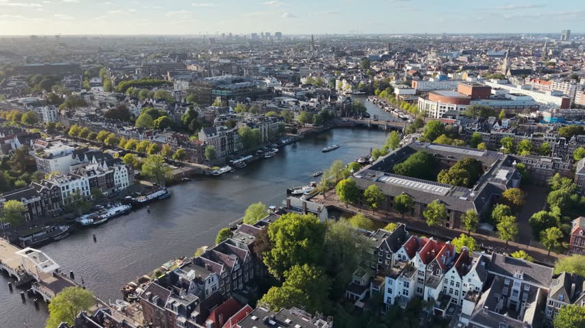 Amsterdam Skyline In Amsterdam In North Holland Netherlands. Beautiful Channels. Downtown District. Amstel River Scenery. Amsterdam Skyline In Netherlands. Stunning Cityscape. Tourism Travel.