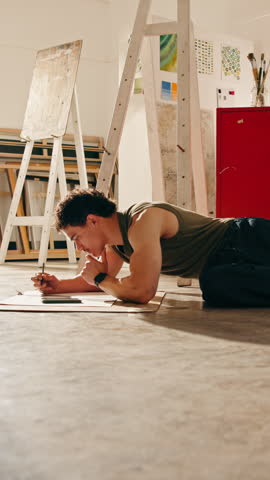 Artist, thinking and man sketching in workshop with break, phone and picture with creativity. Studio, male person and pencil for drawing of portrait with shading, project and tired in series