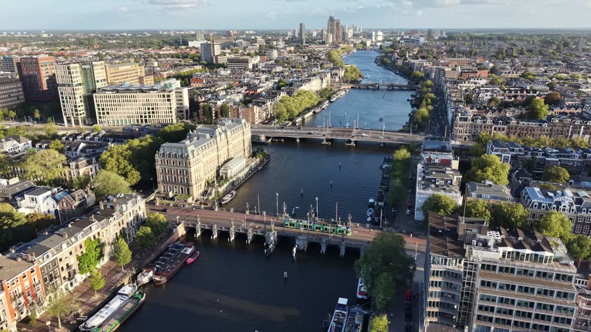 Amsterdam Skyline In Amsterdam In North Holland Netherlands. River Canals Network. Downtown District. Tourism Travel. Amsterdam Skyline In Netherlands. Cultural Heritage. Riverfront Landscape.