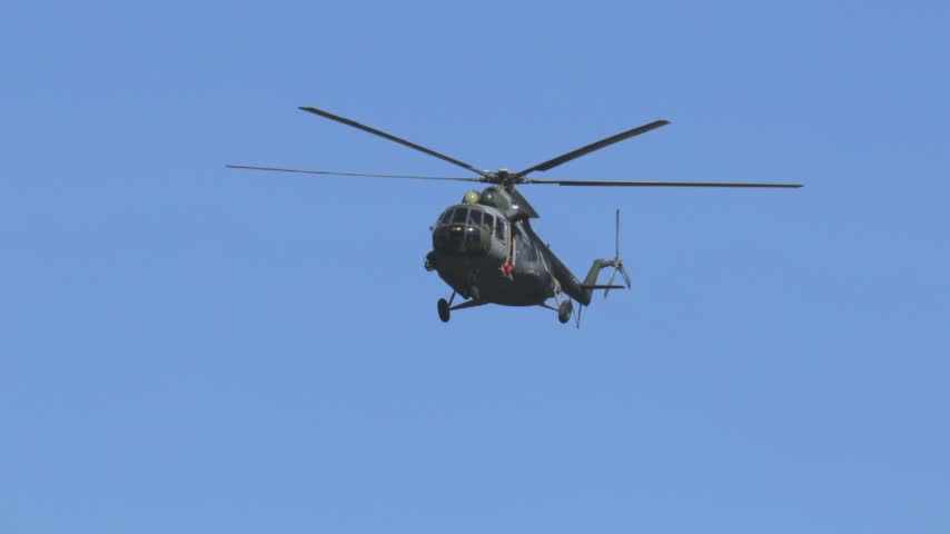 
Mil Mi-17 transport helicopter of the Czech Armed Forces flying across a blue sky