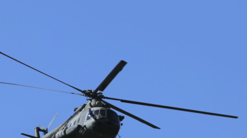 
Mil Mi-17 transport helicopter of the Czech Armed Forces flying across a blue sky