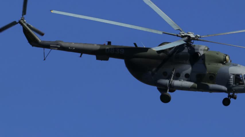 
Mil Mi-17 transport helicopter of the Czech Armed Forces flying across a blue sky
